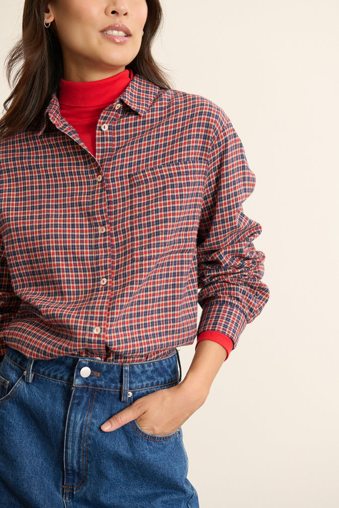 Chemise aux manches longues aux poignets boutonnés, coupe droite et fronces légères au niveau de la tête de manche.